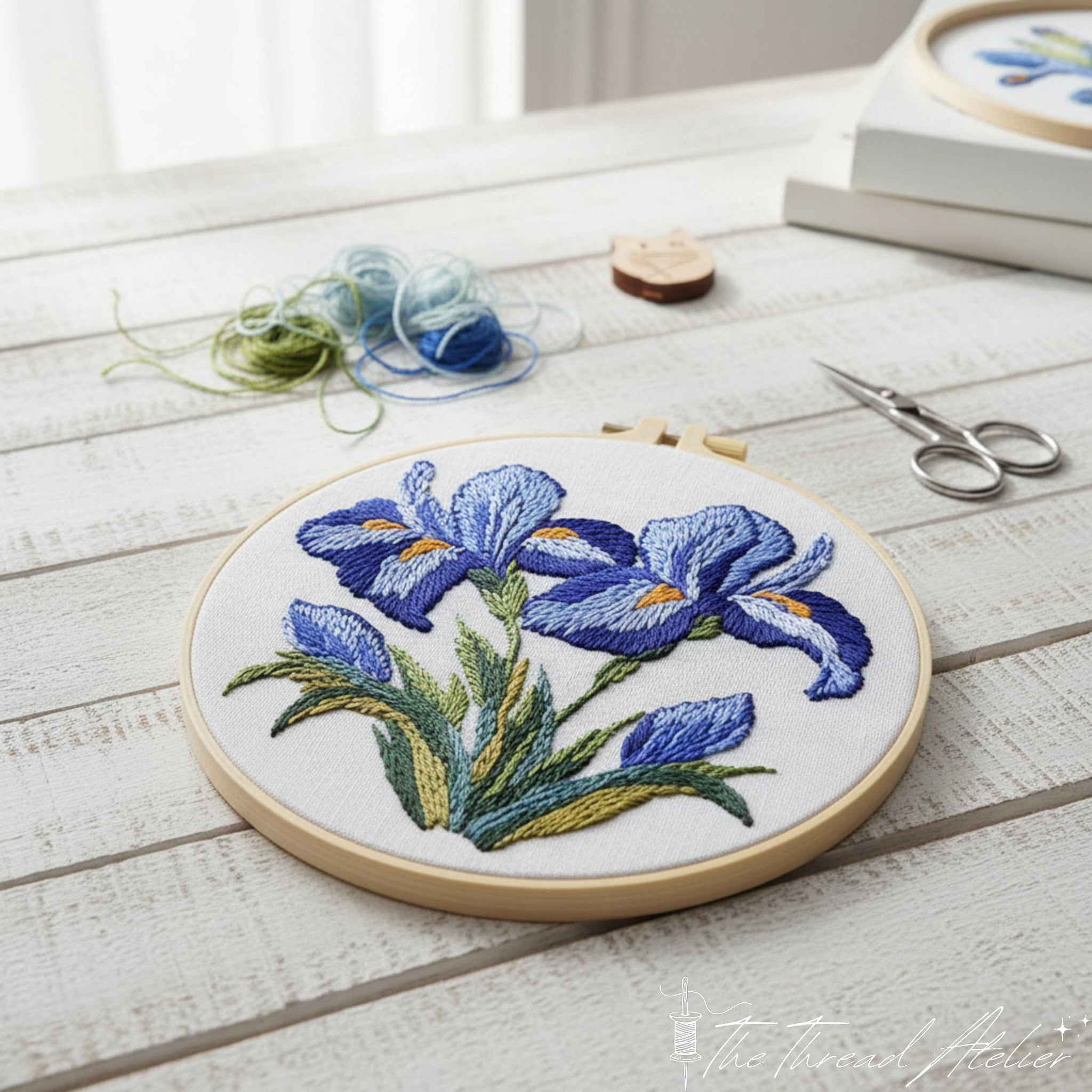 Iris flower needlework stitched in shades of blue and purple