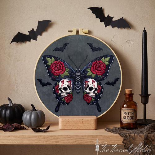 Dark butterfly with white skulls, red roses and green leaves displayed with gothic Halloween decor