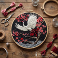 White crane with red tail feathers flying among pink sakura blossoms on dark fabric