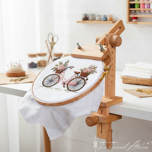 Adjustable wooden embroidery hoop holder clamped to a table edge