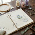 Linen embroidery practice book with blank fabric pages for stitching