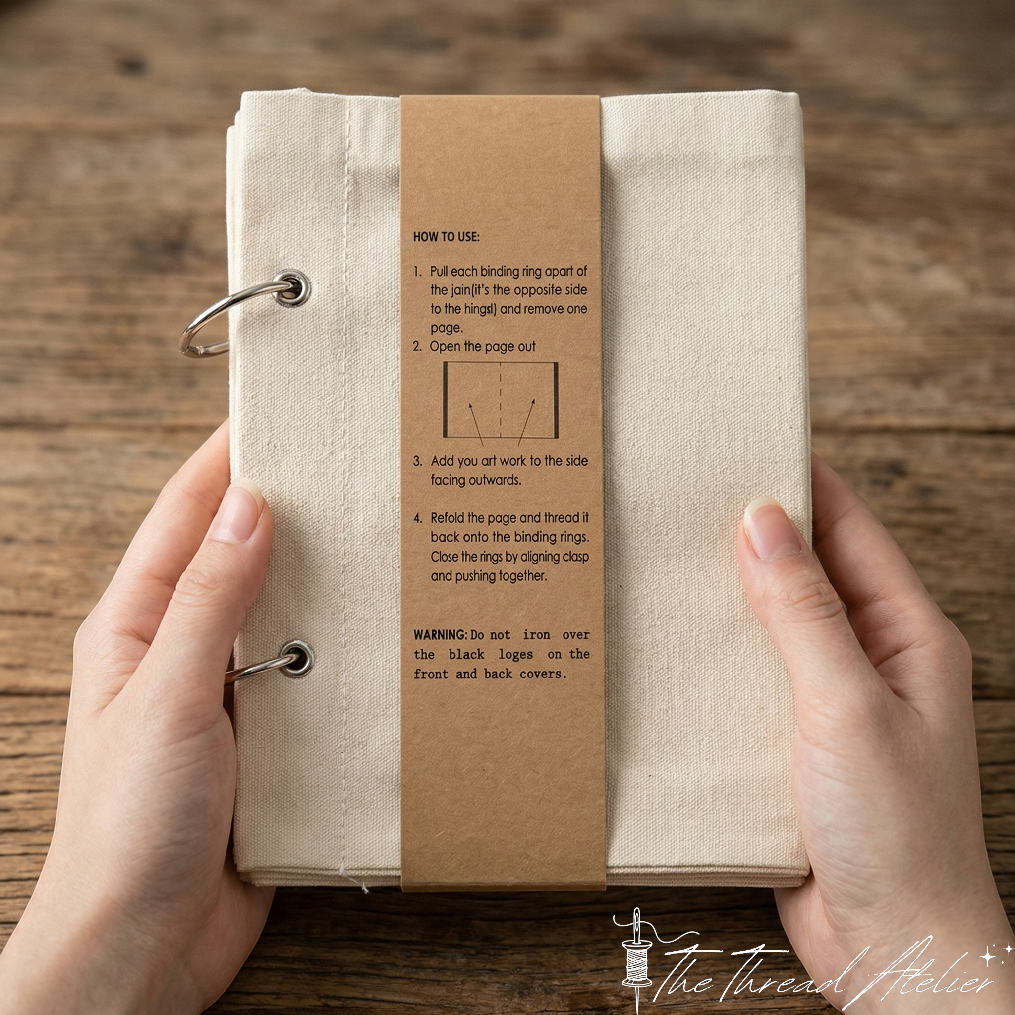 Hand stitch sampler binder open on worked linen pages