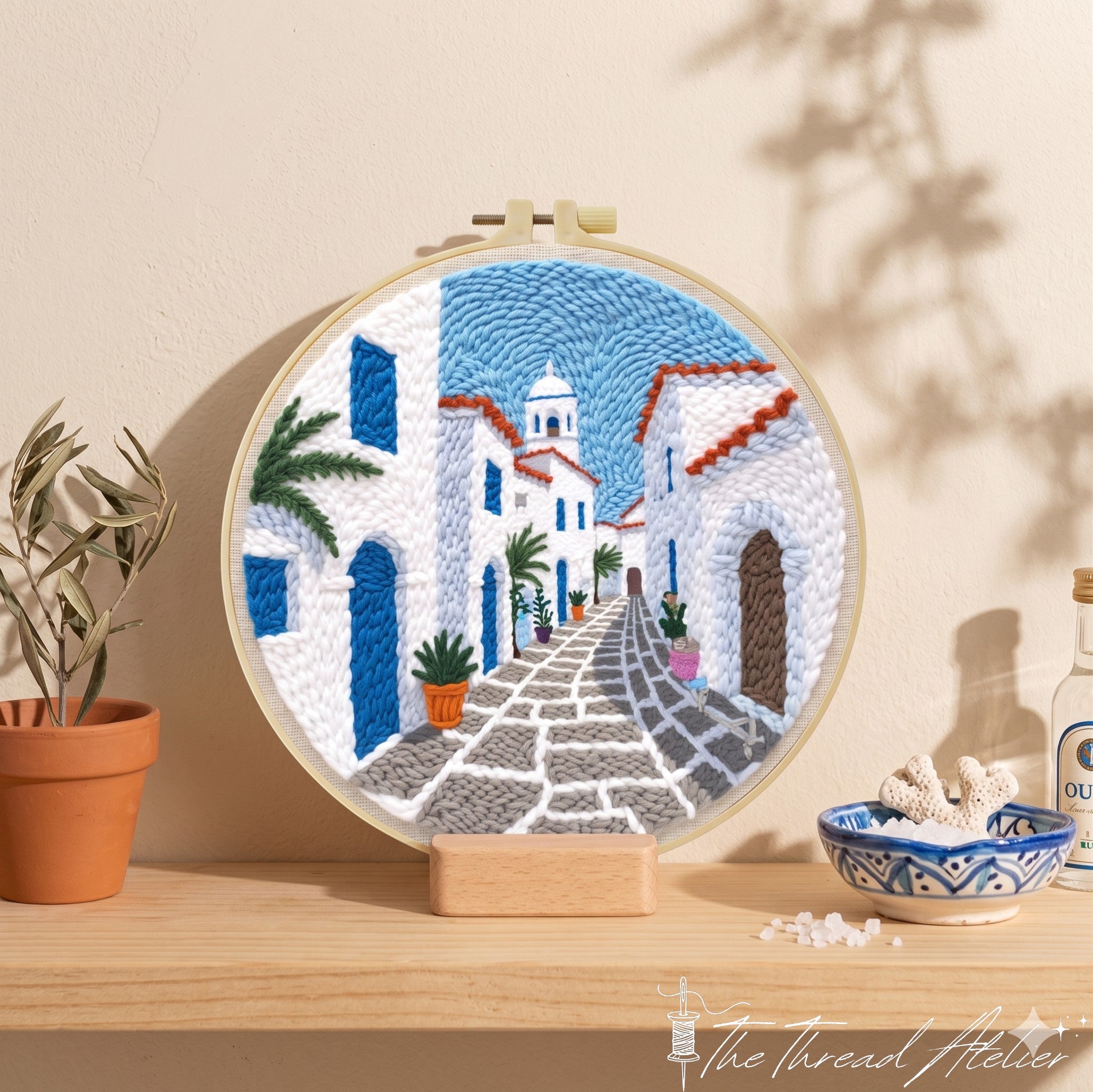 Santorini inspired punch needle scene in blue and white yarn
