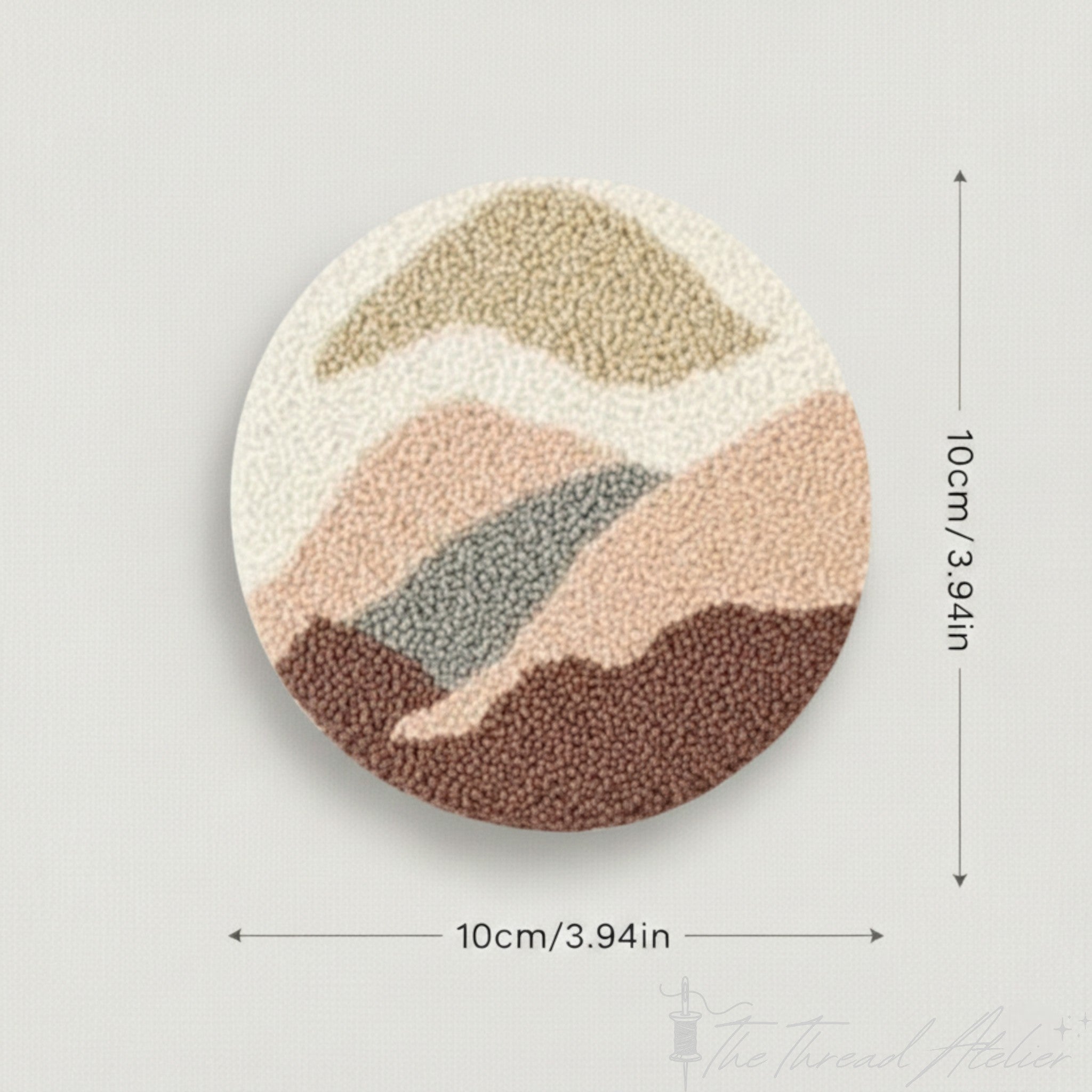 Abstract landscape punch needle coasters set out on a table