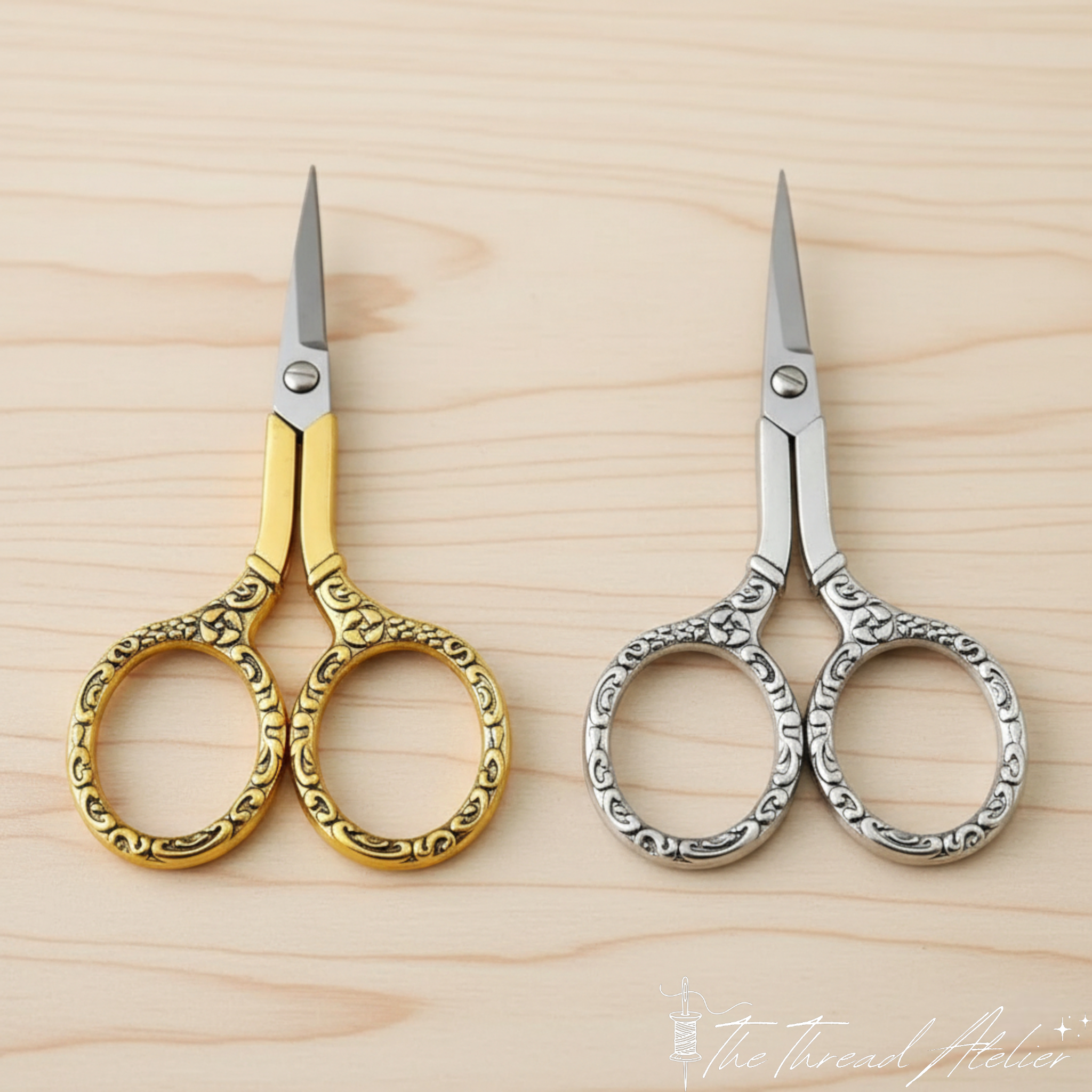Vintage sewing scissors resting on fabric beside embroidery threads