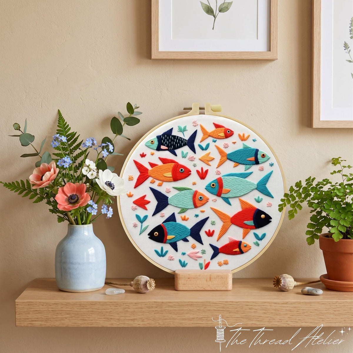 School of fish embroidery on a wooden stand beside flowers, plants and framed botanical art