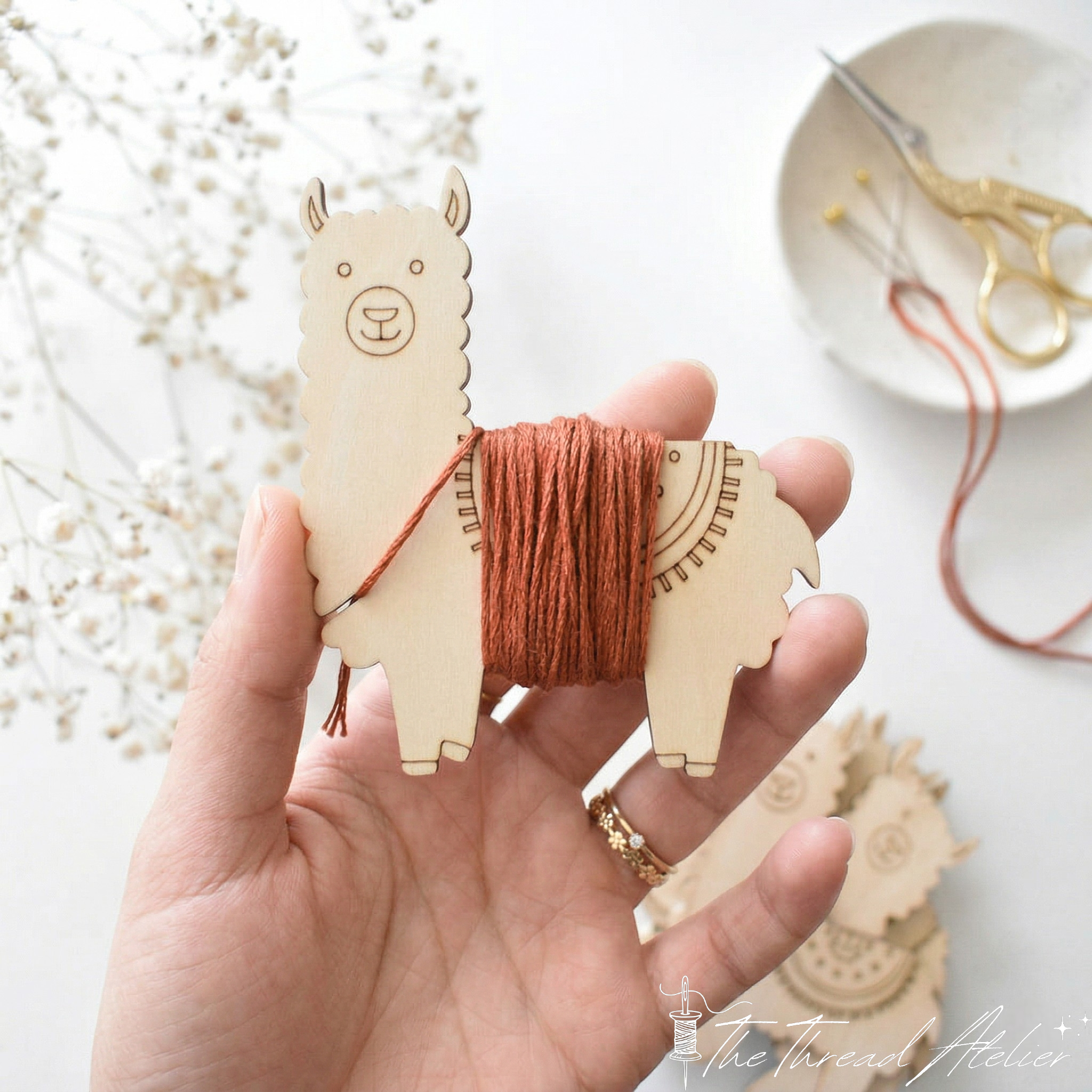 Wooden thread winders holding wound embroidery floss