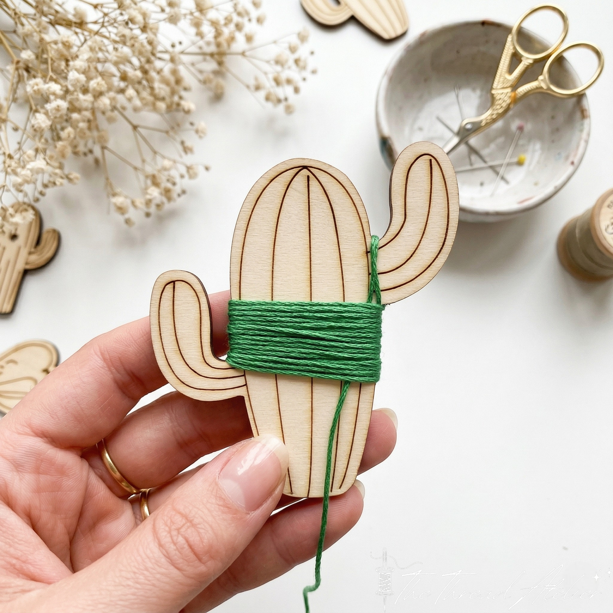 Close view of an animal shaped bobbin cut from natural wood